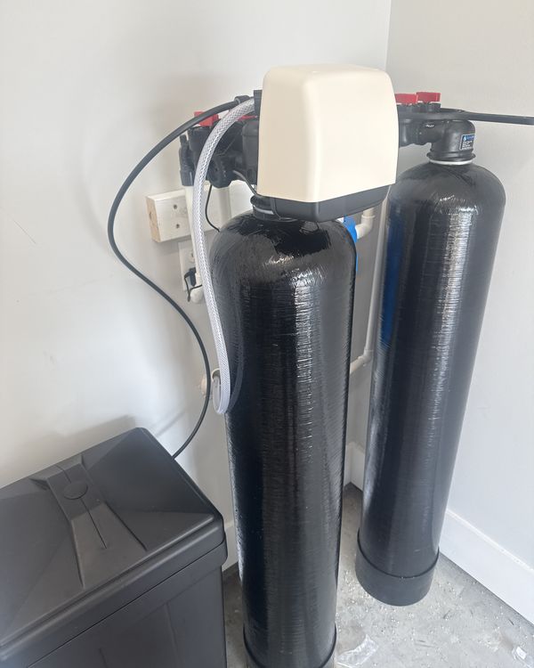 Softener and carbon filter tanks with brine tank installed in a garage